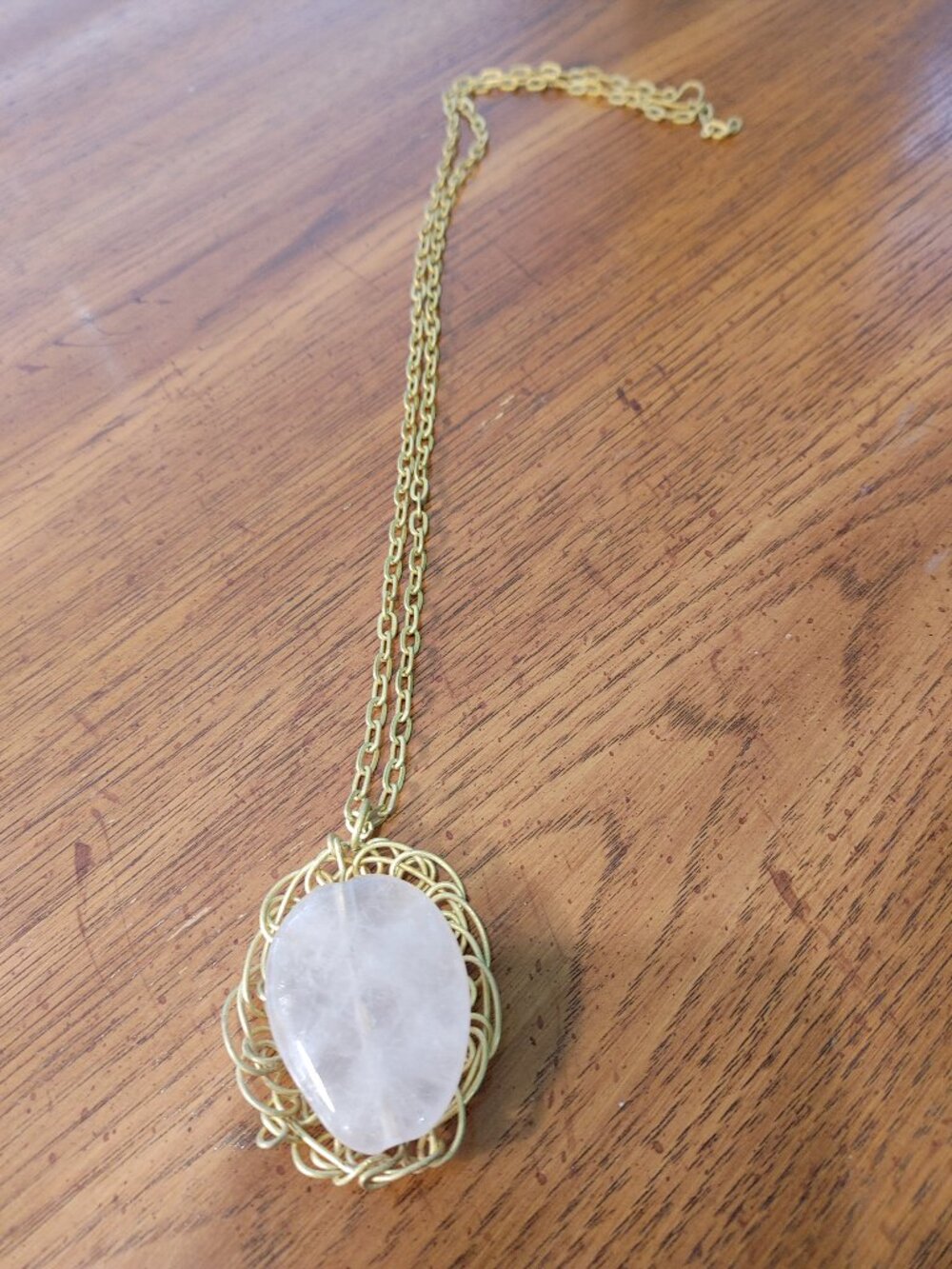 Gold tone necklace with mounted stone